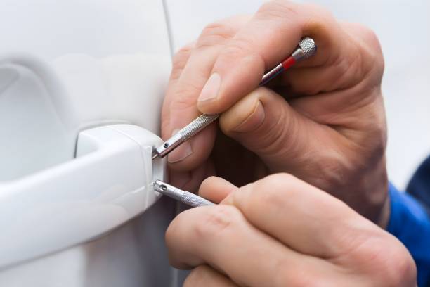 Close-up Of Person Hand Holding Lockpicker To Open Car Door